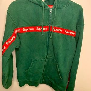 Supreme zip up hoodie. On the second it shows show sowing done. Green and red. M